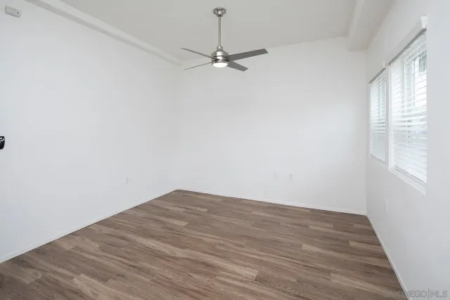 a kitchen with white cabinets and appliances