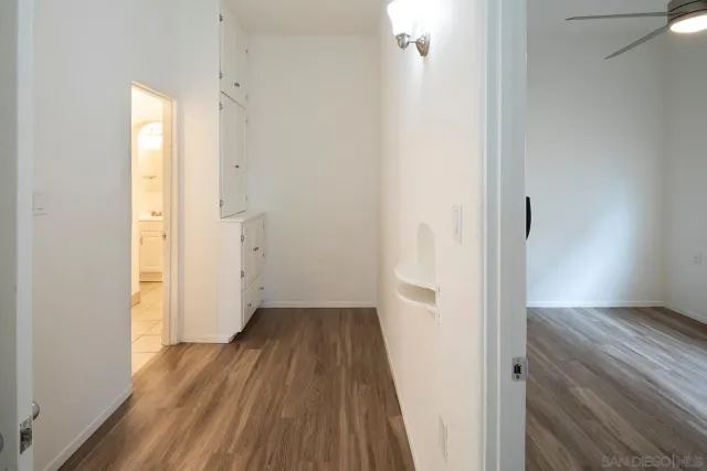 an empty room with a window and a fan