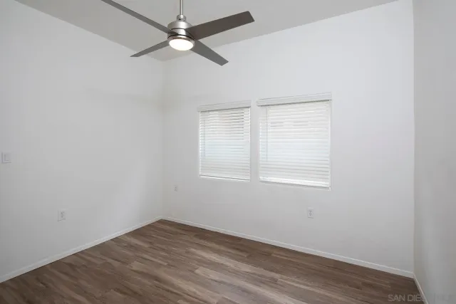 a view of a small space with wooden floor and a window