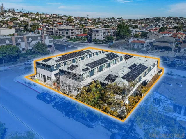 an aerial view of a residential apartment building in a backyard