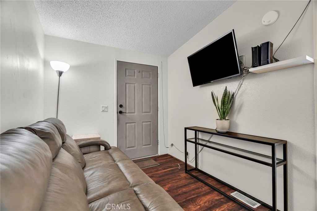 20401 Soledad Canyon Road, Unit 139 Canyon Country, CA 91351 - Photo 14 of 35 a living room with a bed furniture and a flat screen tv