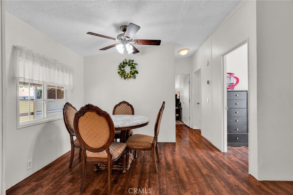 20401 Soledad Canyon Road, Unit 139 Canyon Country, CA 91351 - Photo 16 of 35 a view of a dining room with furniture and wooden floor
