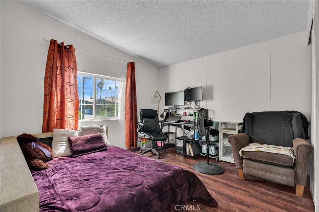 20401 Soledad Canyon Road, Unit 139 Canyon Country, CA 91351 - Photo 18 of 35 a bedroom with furniture and a wooden floor