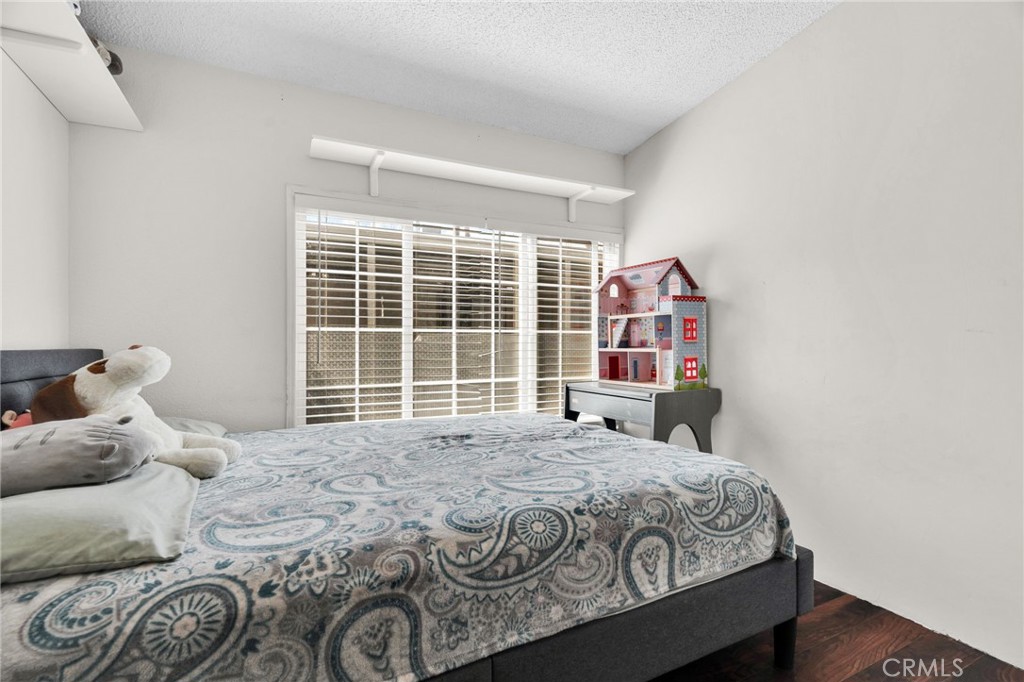 20401 Soledad Canyon Road, Unit 139 Canyon Country, CA 91351 - Photo 21 of 35 a bedroom with a large bed and a window