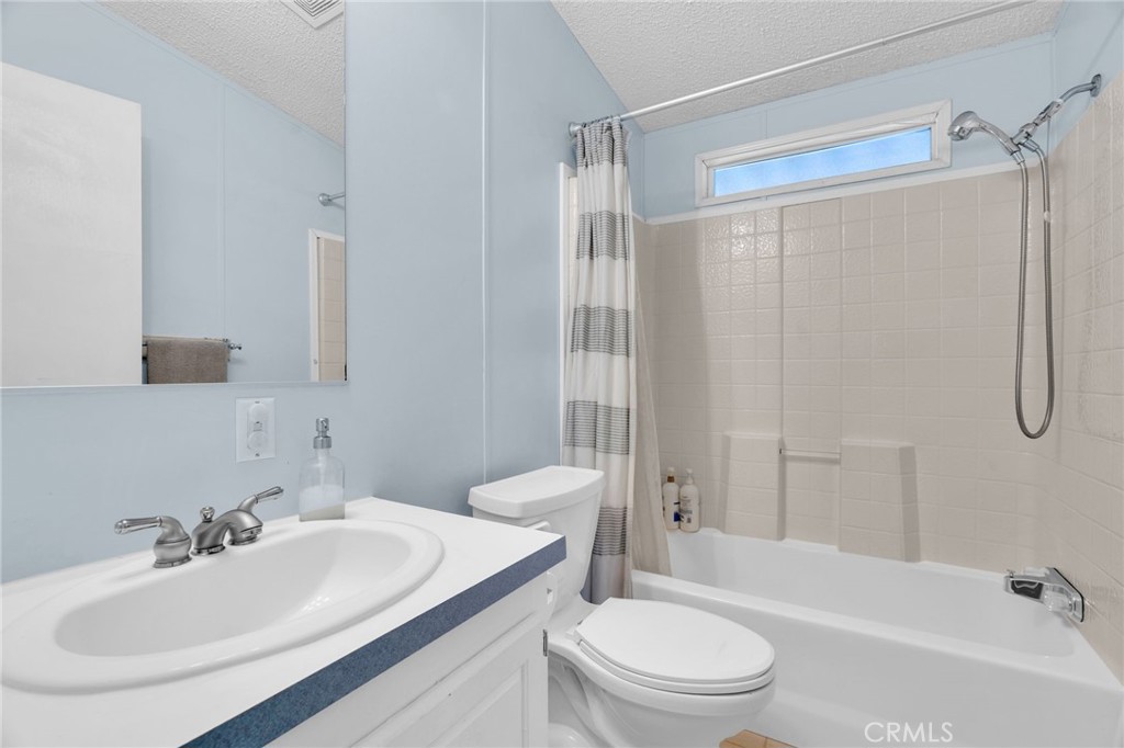 20401 Soledad Canyon Road, Unit 139 Canyon Country, CA 91351 - Photo 24 of 35 a bathroom with a sink toilet and shower