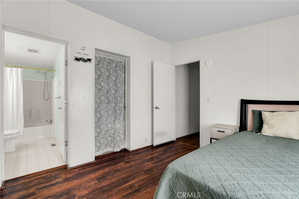 20401 Soledad Canyon Road, Unit 139 Canyon Country, CA 91351 - Photo 26 of 35 a bedroom with a bed and wooden floor