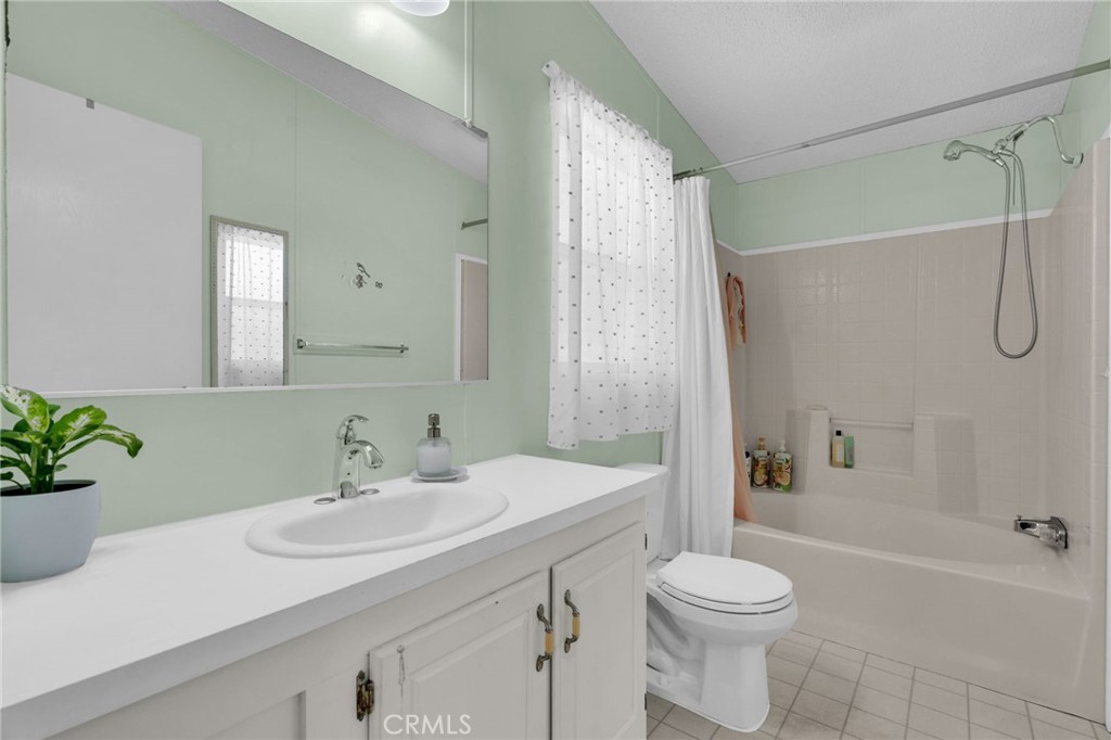 20401 Soledad Canyon Road, Unit 139 Canyon Country, CA 91351 - Photo 27 of 35 a bathroom with a sink toilet and shower
