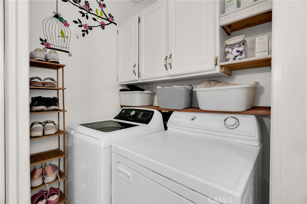 20401 Soledad Canyon Road, Unit 139 Canyon Country, CA 91351 - Photo 28 of 35 a utility room with dryer washer and a fridge