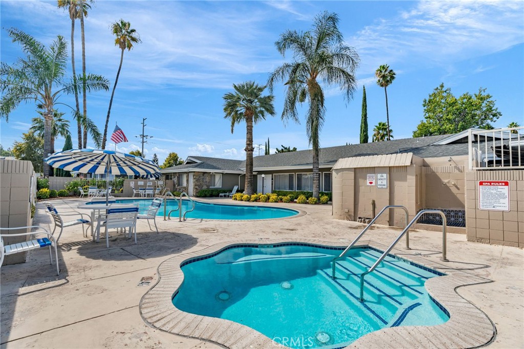 20401 Soledad Canyon Road, Unit 139 Canyon Country, CA 91351 - Photo 30 of 35 a view of a swimming pool with lawn chairs under an umbrella