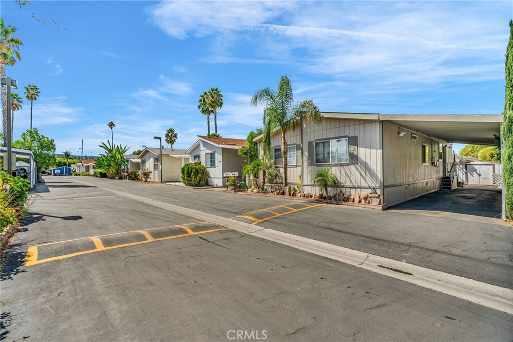 20401 Soledad Canyon Road, Unit 139 Canyon Country, CA 91351 - Photo 32 of 35 a front view of a house with a yard and garage