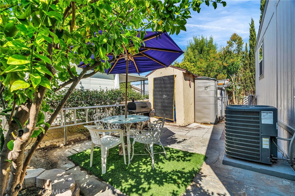 20401 Soledad Canyon Road, Unit 139 Canyon Country, CA 91351 - Photo 5 of 35 an outdoor space with furniture and umbrella