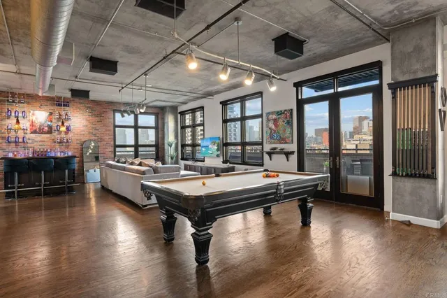 a large bedroom with a bed and wooden floor