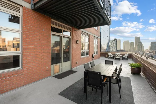 a living room with furniture a flat screen tv and a potted plant