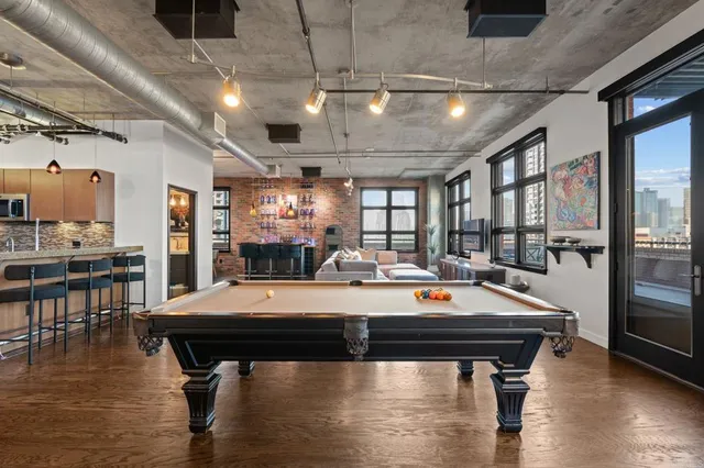 a living room with furniture a floor to ceiling window and a flat screen tv