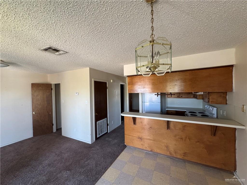 1810 Jason Avenue Edinburg, TX 78539 - Photo 12 of 27 a kitchen with stainless steel appliances granite countertop a sink and a refrigerator