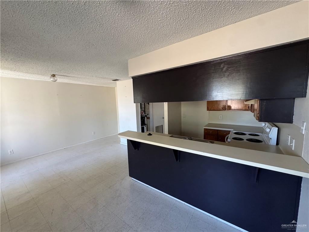 1810 Jason Avenue Edinburg, TX 78539 - Photo 19 of 27 a kitchen with stainless steel appliances a sink stove and refrigerator