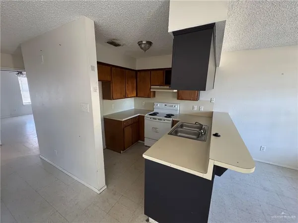 a kitchen with a sink appliances and cabinets