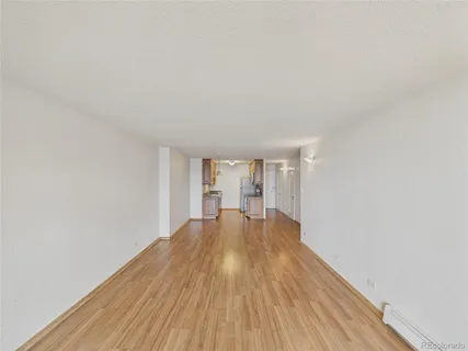a view of empty room with wooden floor