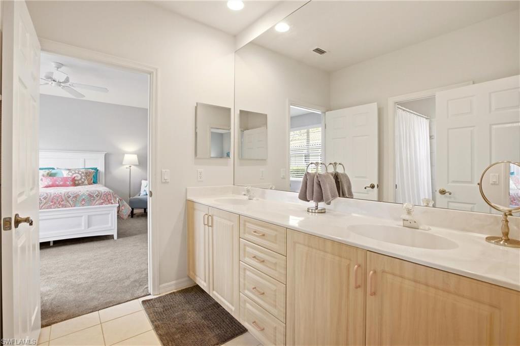 10815 Phoenix Way Naples, FL 34119 - Photo 22 of 40 a en suite bathroom with double sink and a mirror