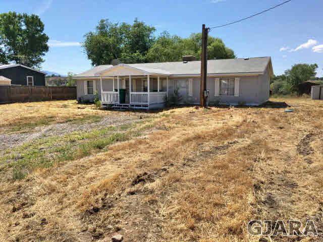 532 34 Road, Unit A Clifton, CO 81520 - Photo 1 of 11 a front view of a house with a yard
