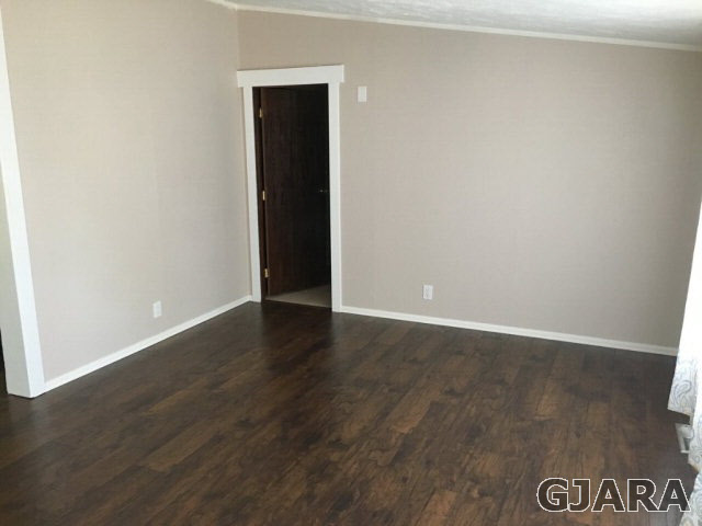 532 34 Road, Unit A Clifton, CO 81520 - Photo 2 of 11 an empty room with wooden floor and cabinet