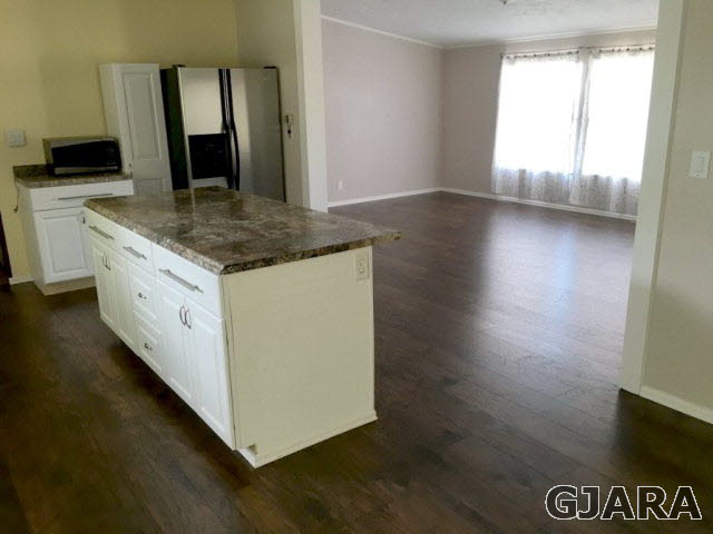 532 34 Road, Unit A Clifton, CO 81520 - Photo 3 of 11 a view of a kitchen island with a sink wooden floor and a large window