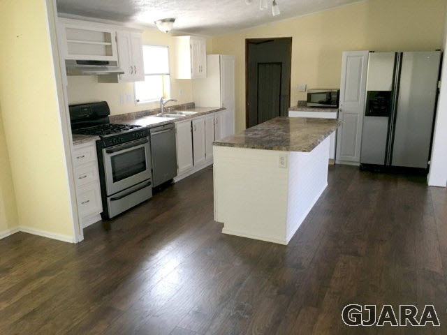 532 34 Road, Unit A Clifton, CO 81520 - Photo 4 of 11 a kitchen with granite countertop a stove and a refrigerator