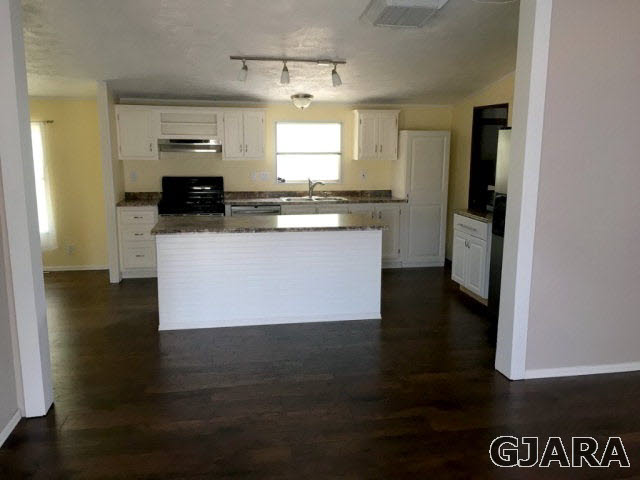 532 34 Road, Unit A Clifton, CO 81520 - Photo 5 of 11 a kitchen with a refrigerator and a stove top oven
