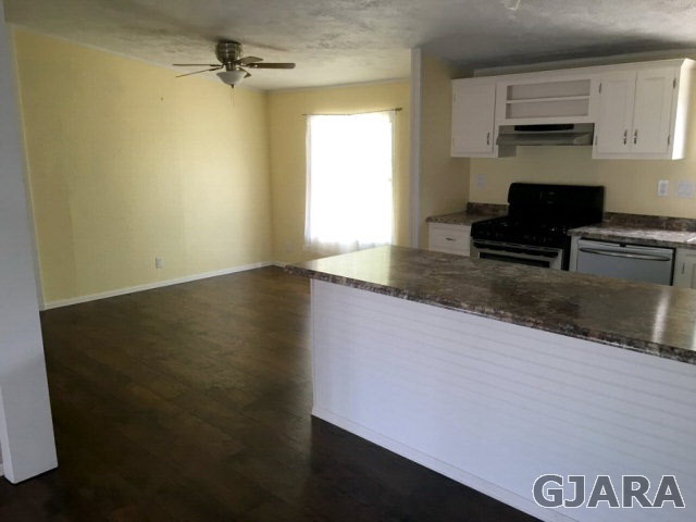 532 34 Road, Unit A Clifton, CO 81520 - Photo 6 of 11 a kitchen with a refrigerator and a stove top oven