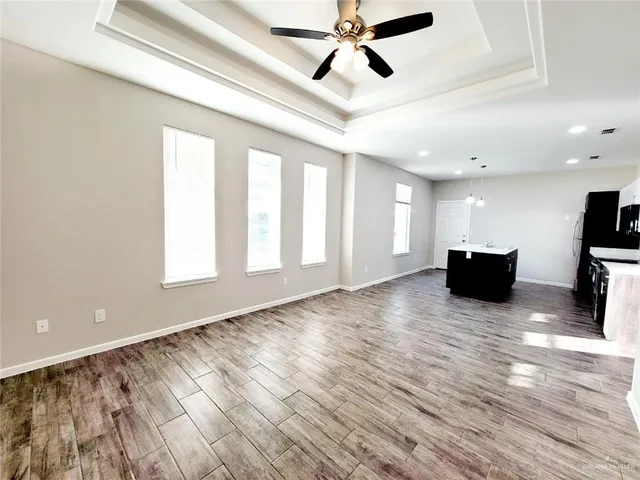 a view of a livingroom with a window and wooden floor