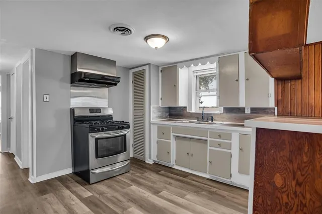 a kitchen with stainless steel appliances granite countertop a stove and a sink