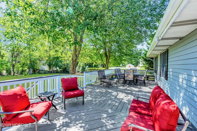 an outdoor sitting area with chairs and wooden fence
