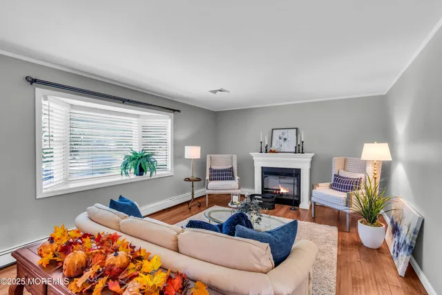 a living room with furniture fireplace and a large window