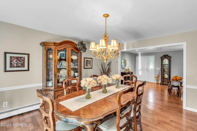 a view of a dining room with furniture wooden floor and chandelier