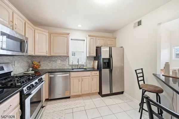 a spacious bedroom with a bed and a view of bathroom