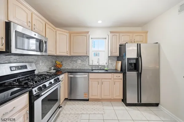 a living room filled with furniture and a floor to ceiling window