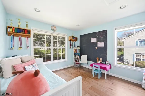 a front view of a house with a yard and a garden