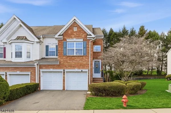 a living room with furniture wooden floor and painting on the wall
