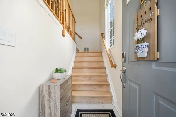 a view of a dining room with furniture a rug and wooden floor