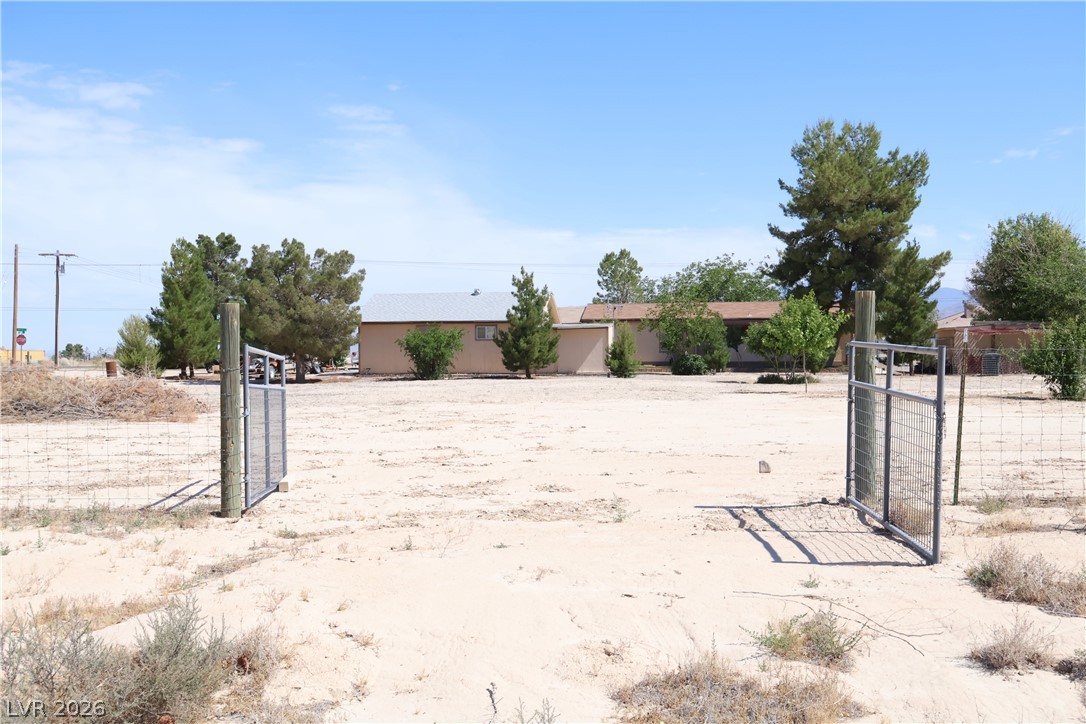 4501 East Kellogg Road Pahrump, NV 89061 - Photo 42 of 52 Secure entry gates define the perimeter of this expansive, arid desert lot.