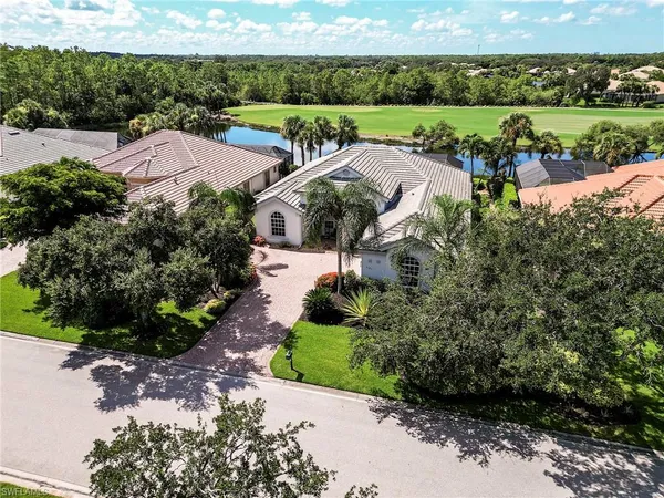 an aerial view of a house with garden space and street view