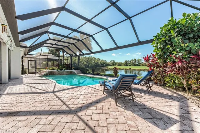 a view of a patio with a table and chairs under an umbrella