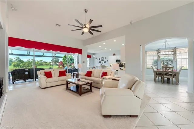 a living room with furniture and floor to ceiling windows