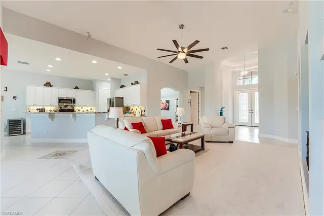 a living room with furniture and kitchen view