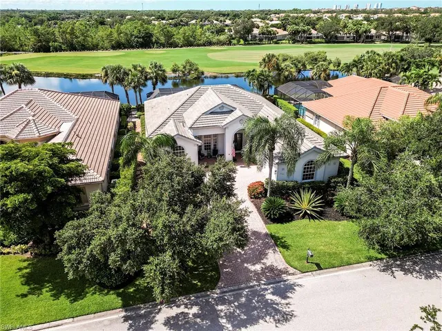 an aerial view of a house with outdoor space and lake view