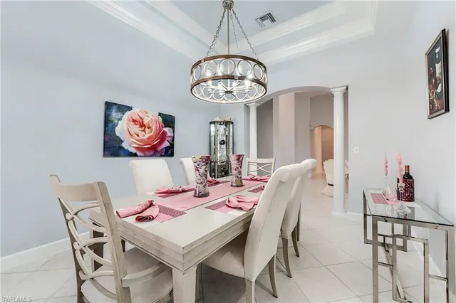a view of a dining room with furniture chandelier and a chandelier
