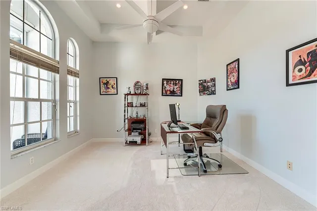 a view of a workspace with furniture and a window