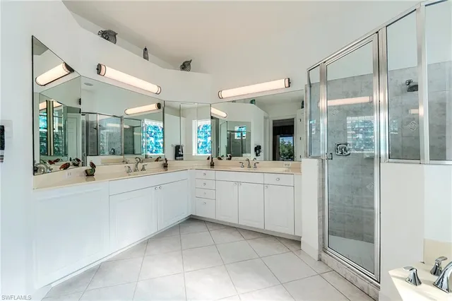 a large white bathroom with a granite countertop sink mirror and bathtub
