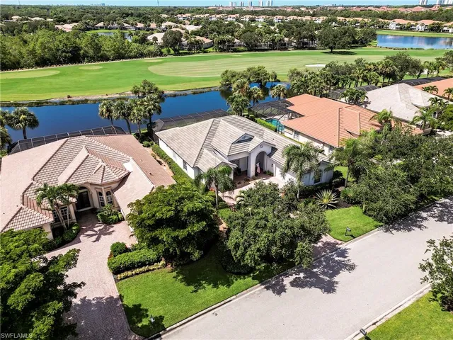 an aerial view of a house with outdoor space lake view and mountain view in back yard