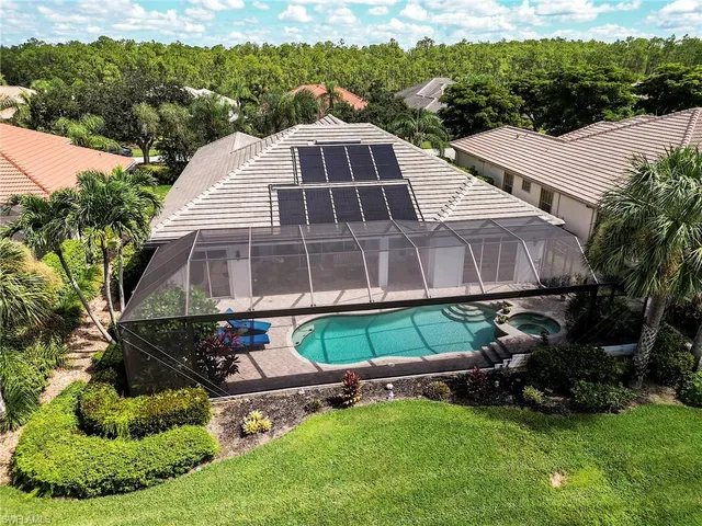 a aerial view of a house with a yard and lake view